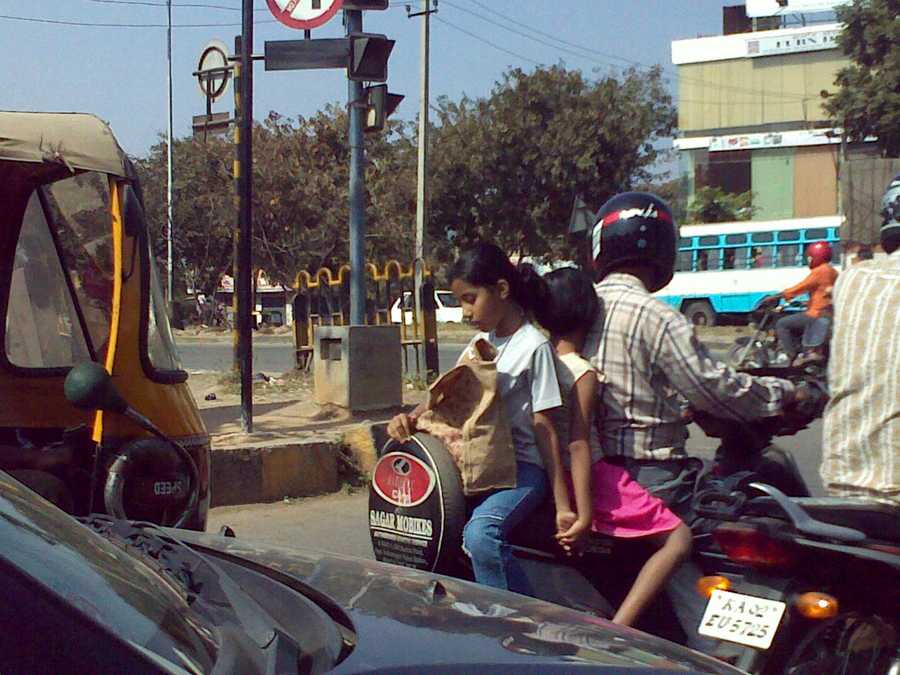 Two kids on the pillion seat
